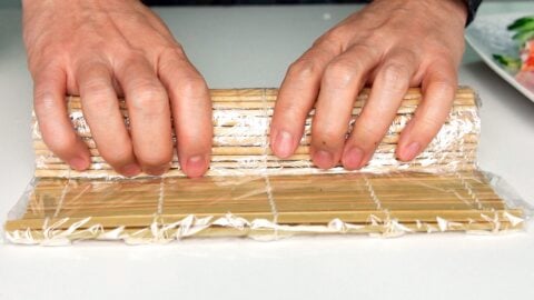 The bamboo sushi matt helps shape the sushi roll.