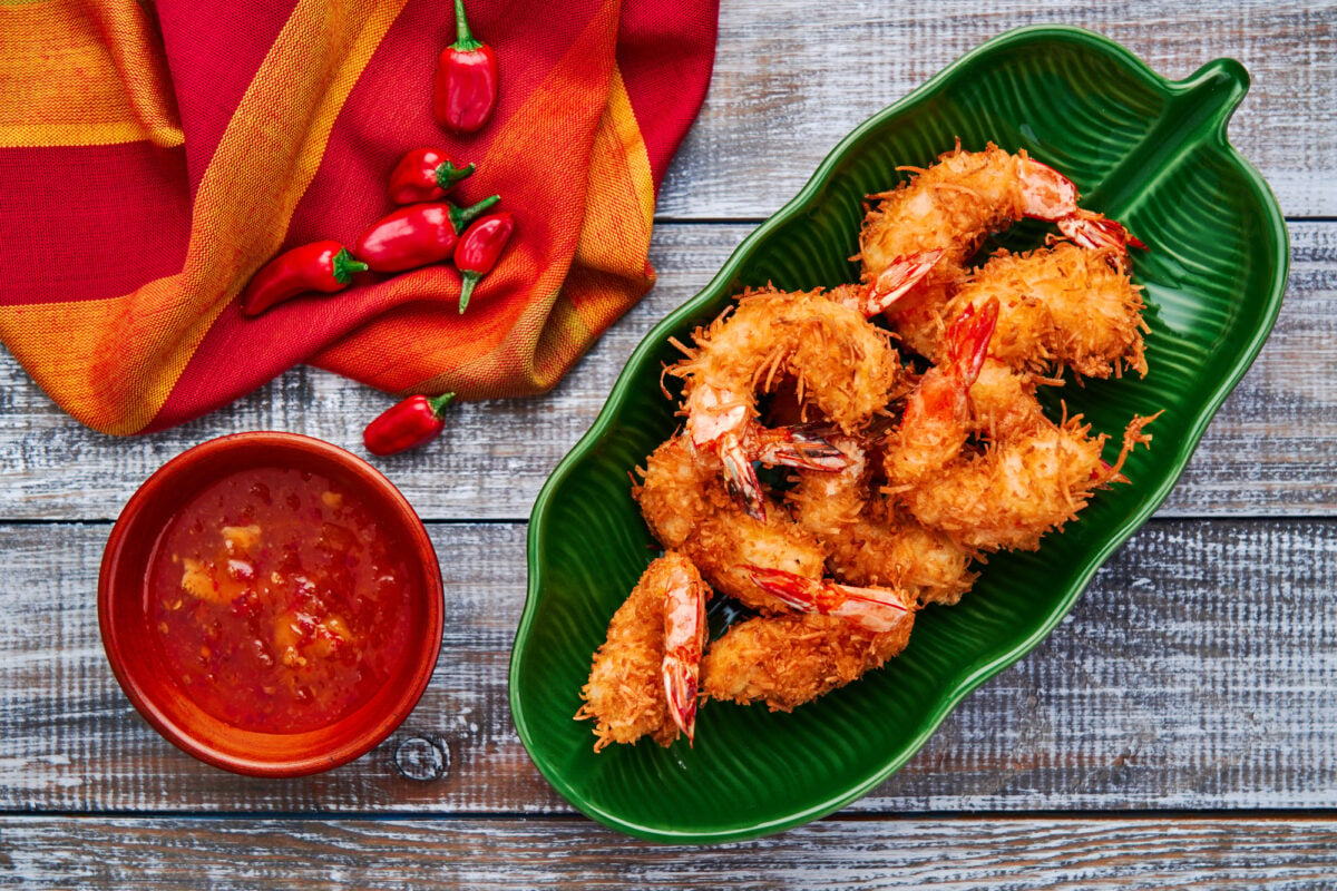 Crispy coconut shrimp with a sweet and sour spicy orange dipping sauce.