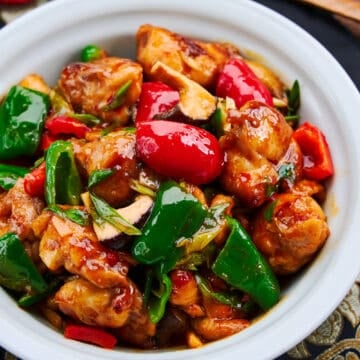 Hunan chicken is an easy weeknight stir fry featuring juicy hunks of marinated chicken and a vibrant medley of peppers in a spicy sauce with a bright tang.