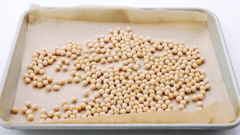 Spread soybeans on a parchment paper lined baking sheet.