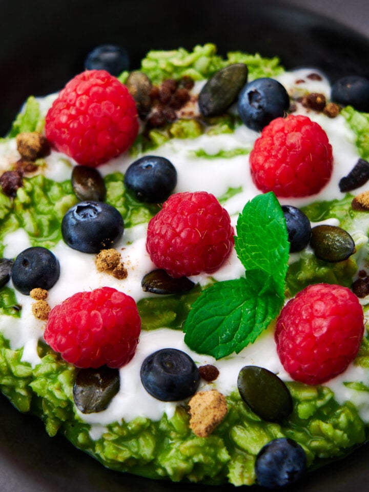 Matcha oatmeal makes for a delicious healthy breakfast with loads of fiber and antioxidents with a kick of caffeine. Topped with coconut cream, fresh berries, and pumpkin seeds.