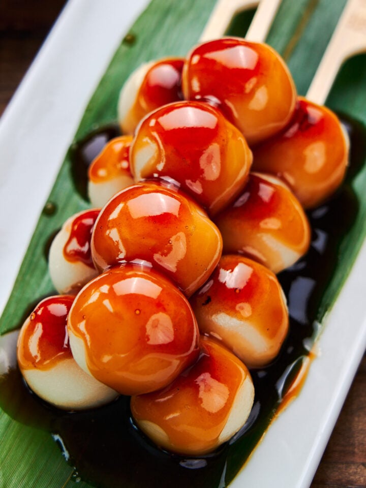 Soft, springy grilled rice dumplings glazed with a sweet and savory sauce. These traditional Japanese Mitarashi Dango make for a delicious snack.