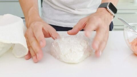Shaping the salmon rice ball into a triangle.