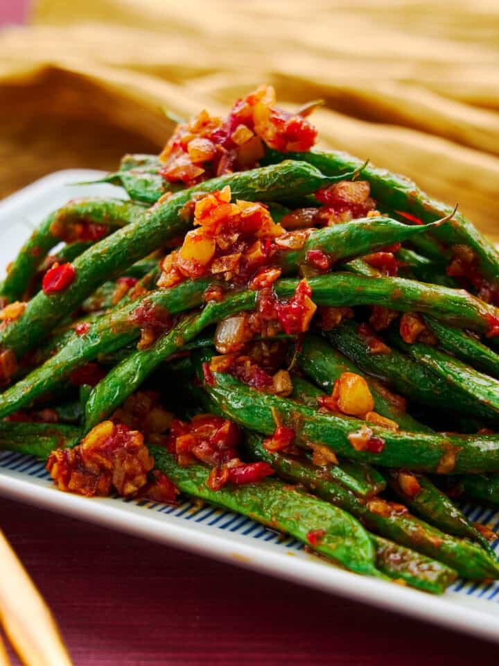 Mound of green beans stir fried with garlic and chili paste. An easy vegan Chiense stir-fry.