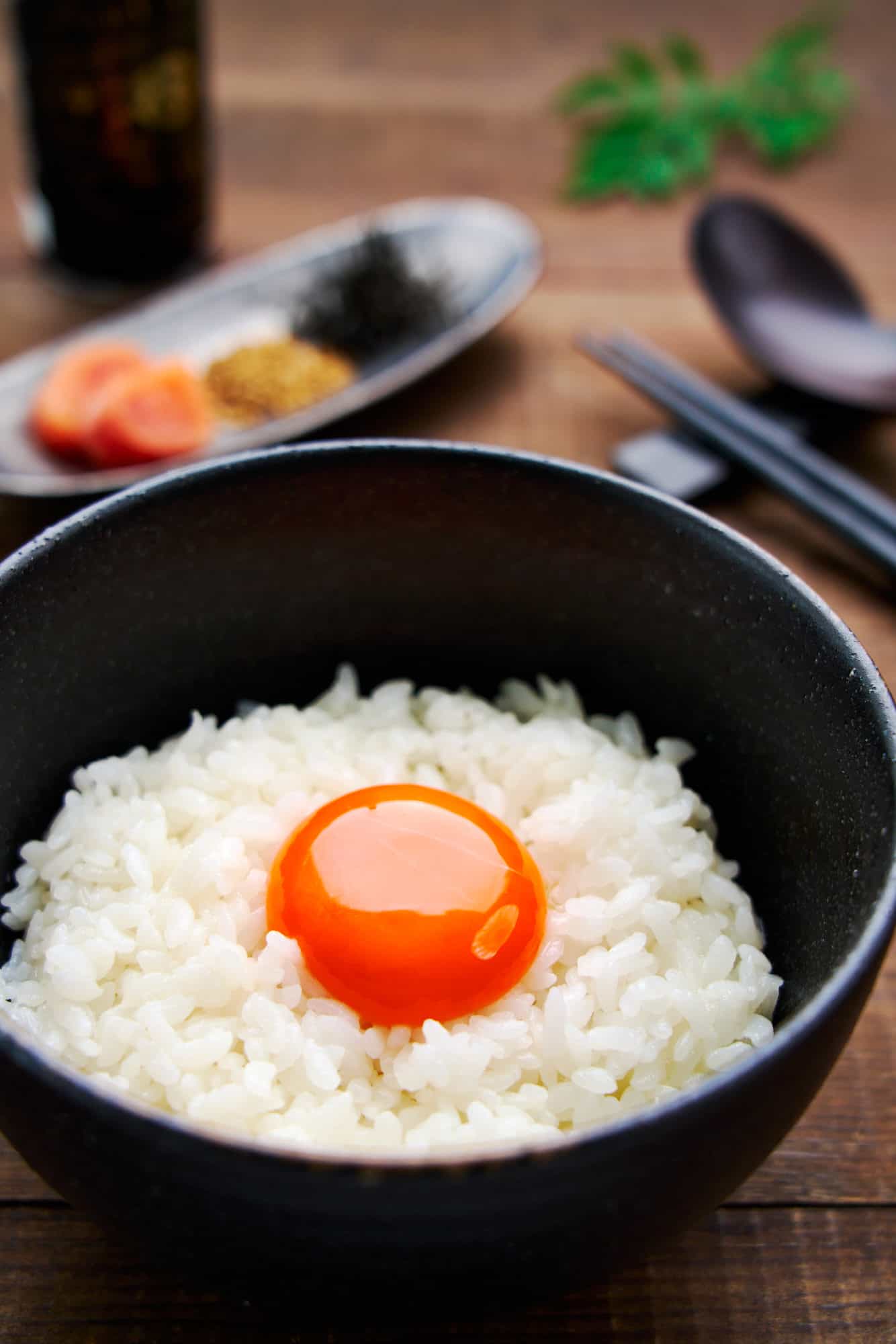 Tamago Kake Gohan is a popular Japanese breakfast food and this on features a vibrant orange egg yolk over a bed of piping hot rice