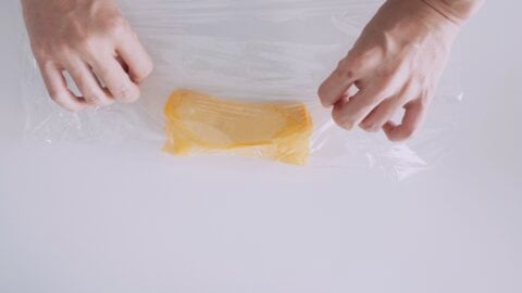 Shaping Tamagoyaki using plastic wrap.