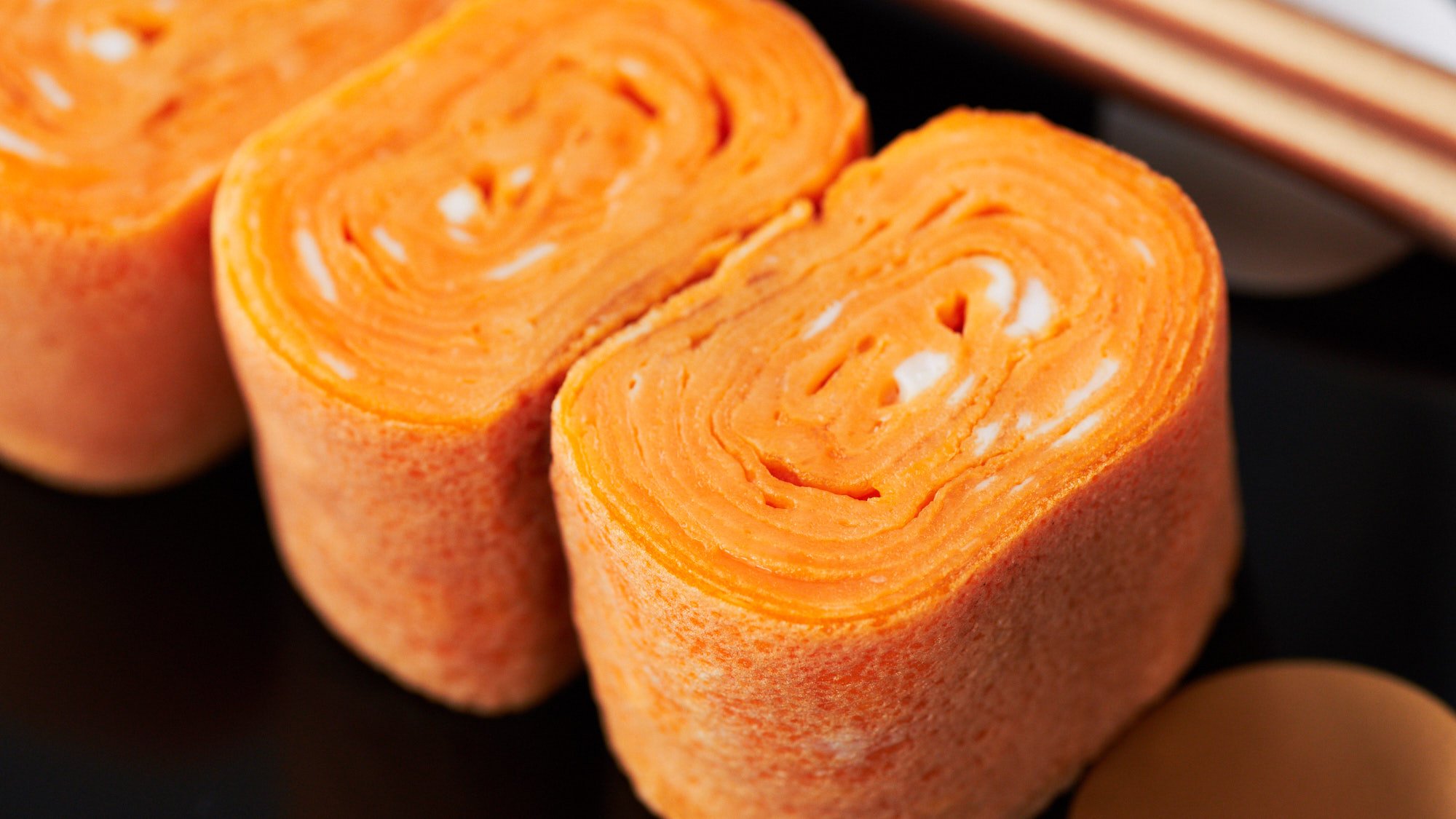 Tamagoyaki is a layered Japanese omelette made by rolling thin sheets of seasoned egg into a roll.